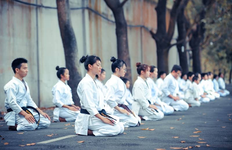 group of martial artists sitting on the ground