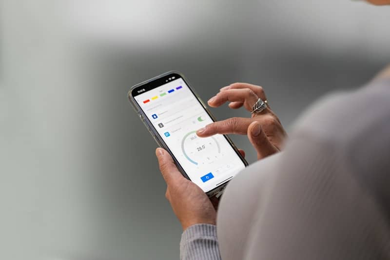 Hands holding a smartphone displaying a mobile application.