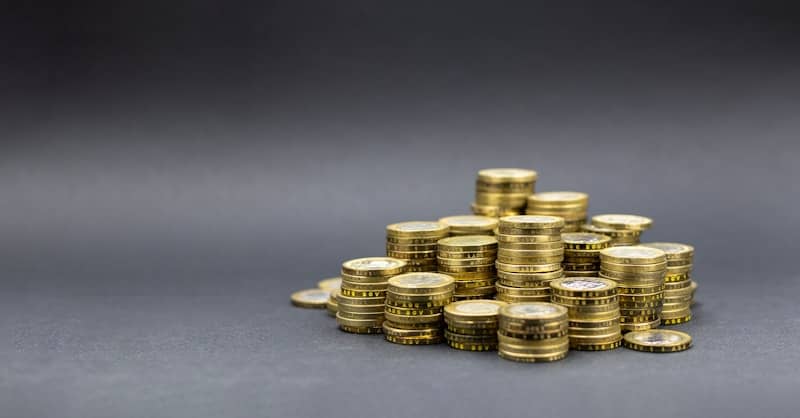 A pile of gold coins on a dark background