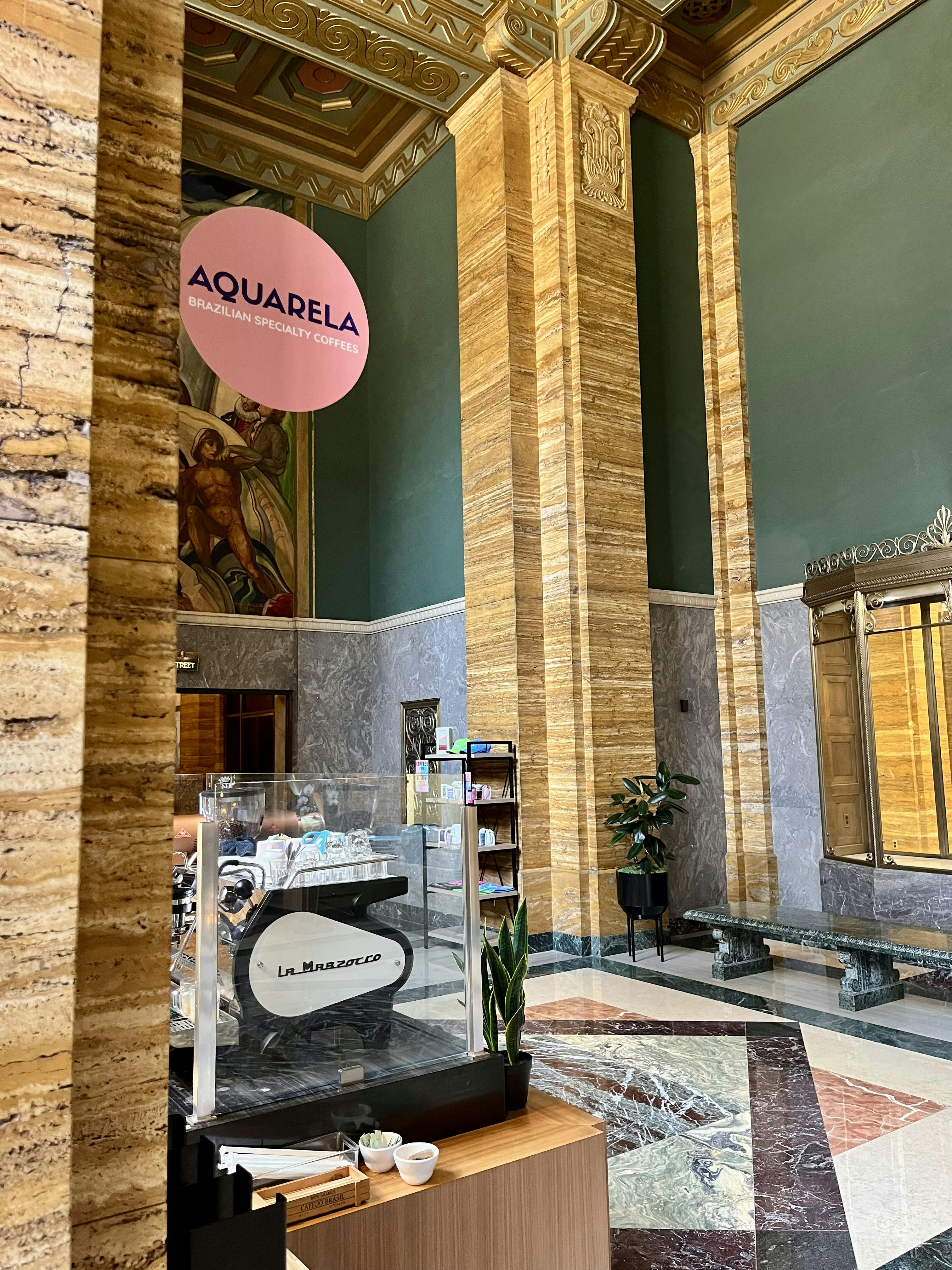 Aquarela Coffee Shop in the lobby of an art deco building with geometric terrrazo  floorr