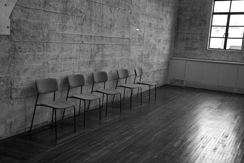 Row of chairs against a textured wall