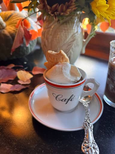 Chocolate Budino. Pudding with salted caramel and maple whipped cream topping in a cafe espresso cup.