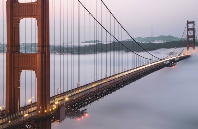 Golden gate bridge emerging from fog at dusk