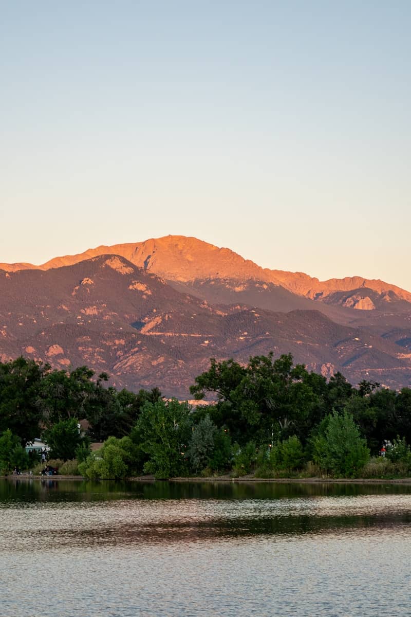 a large body of water with a mountain in the background