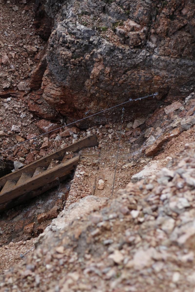 Wooden stairs built into a rocky mountainside.