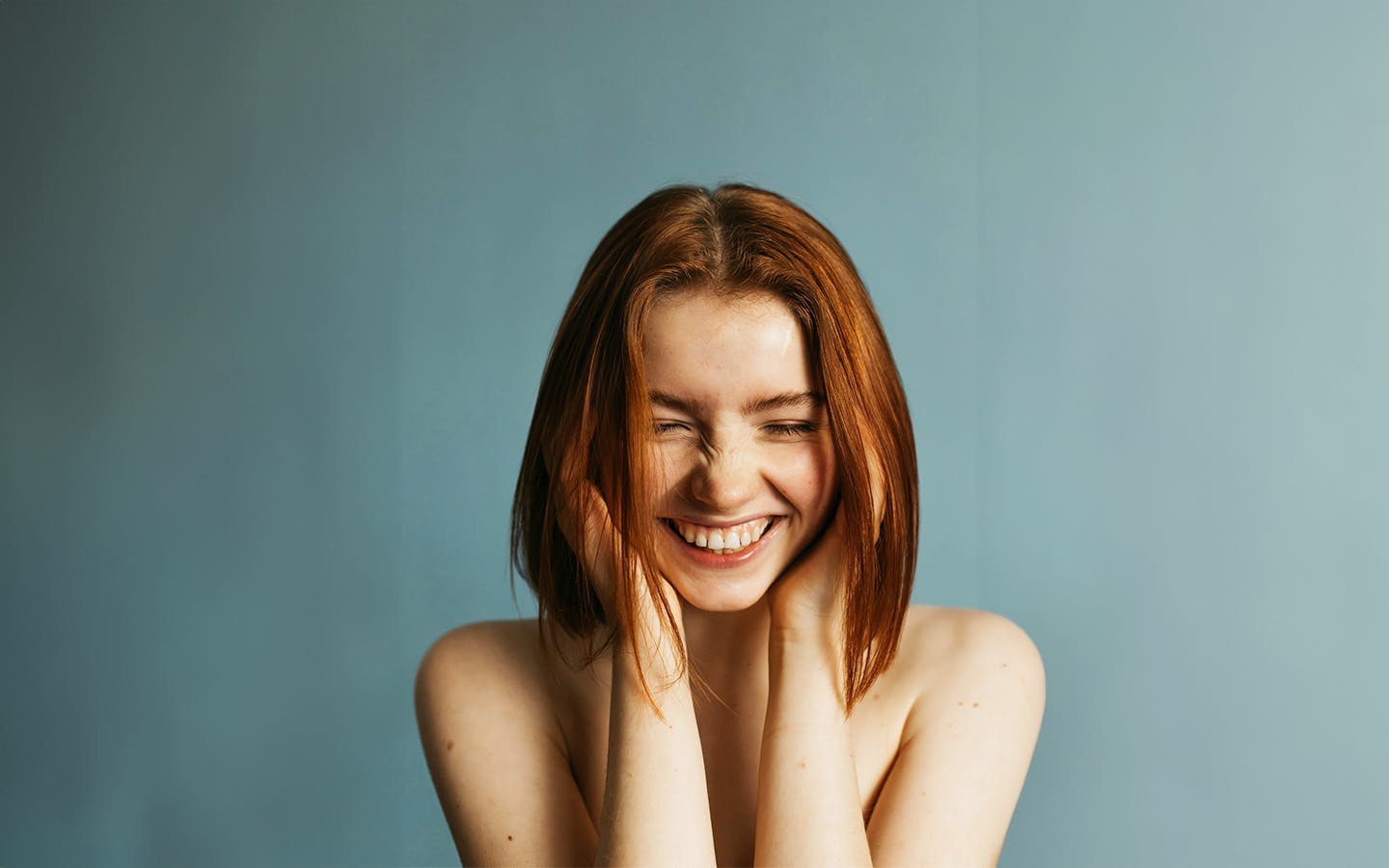 Woman smiling with eyes closed