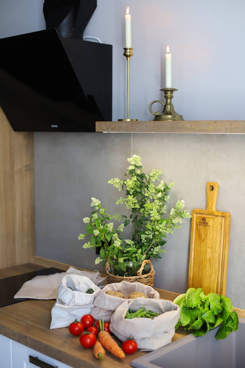 A kitchen counter with a bunch of vegetables on it