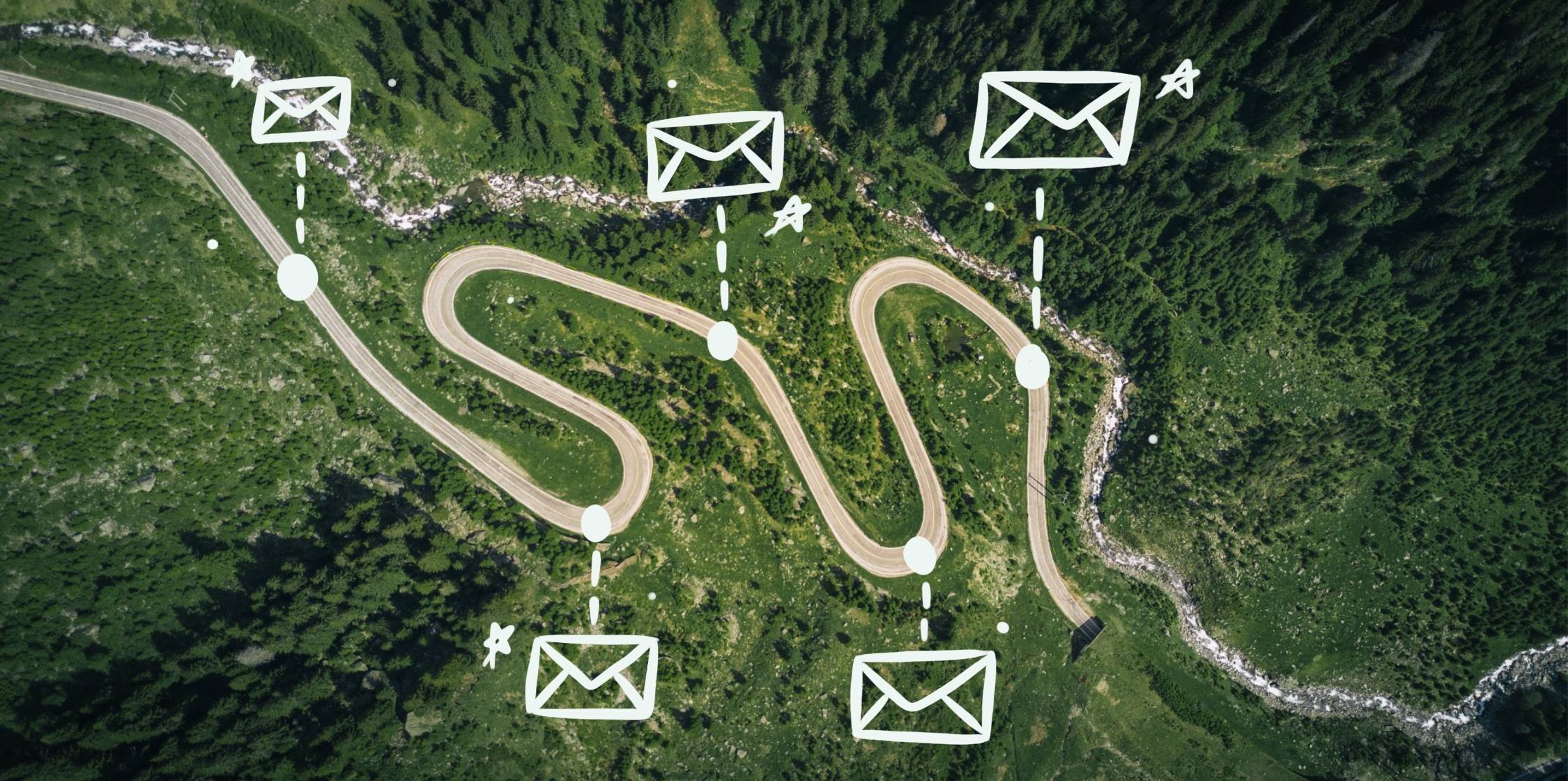 Aerial view of a winding road with envelope icons along it