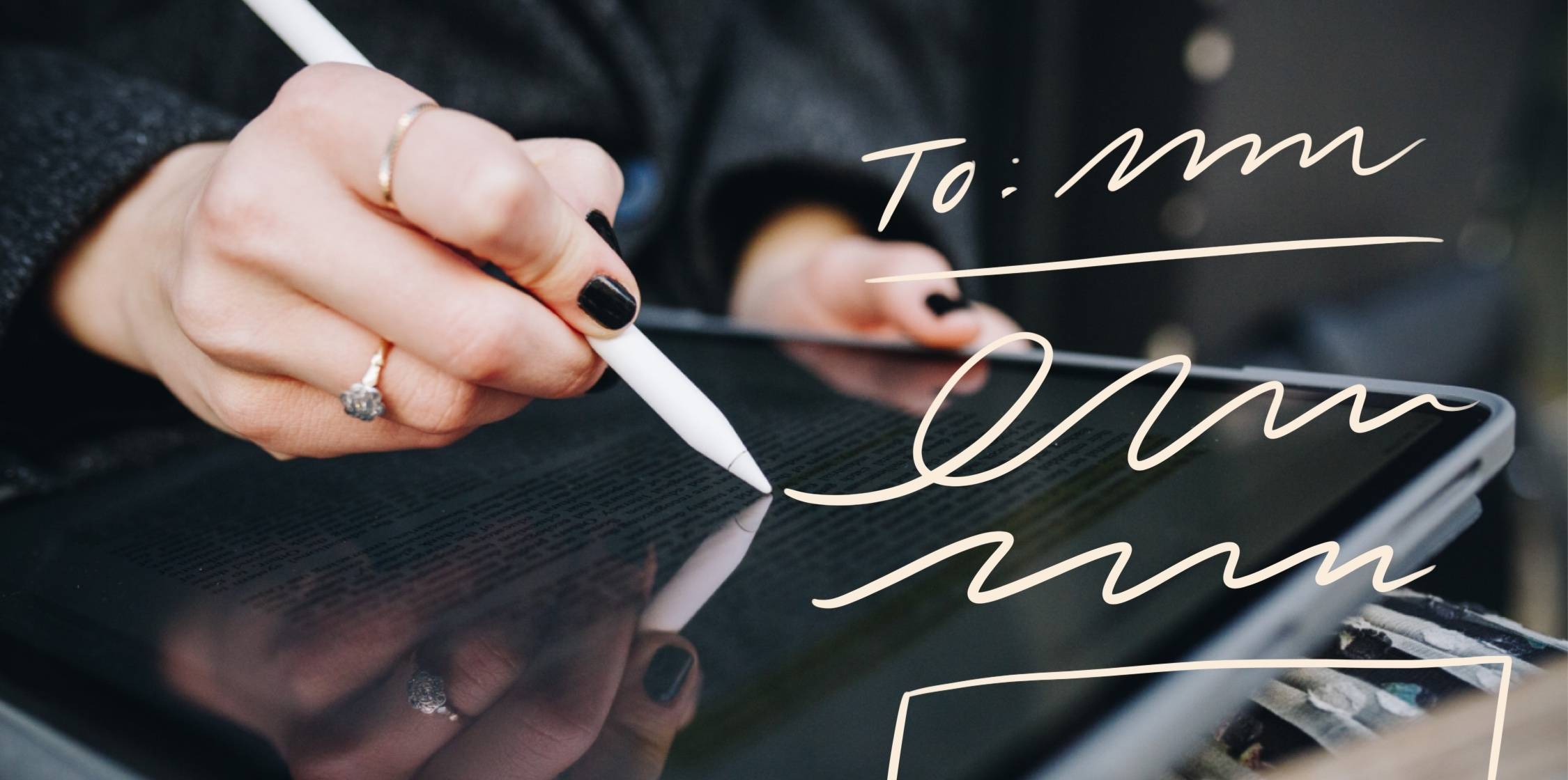 person writing on an ipad