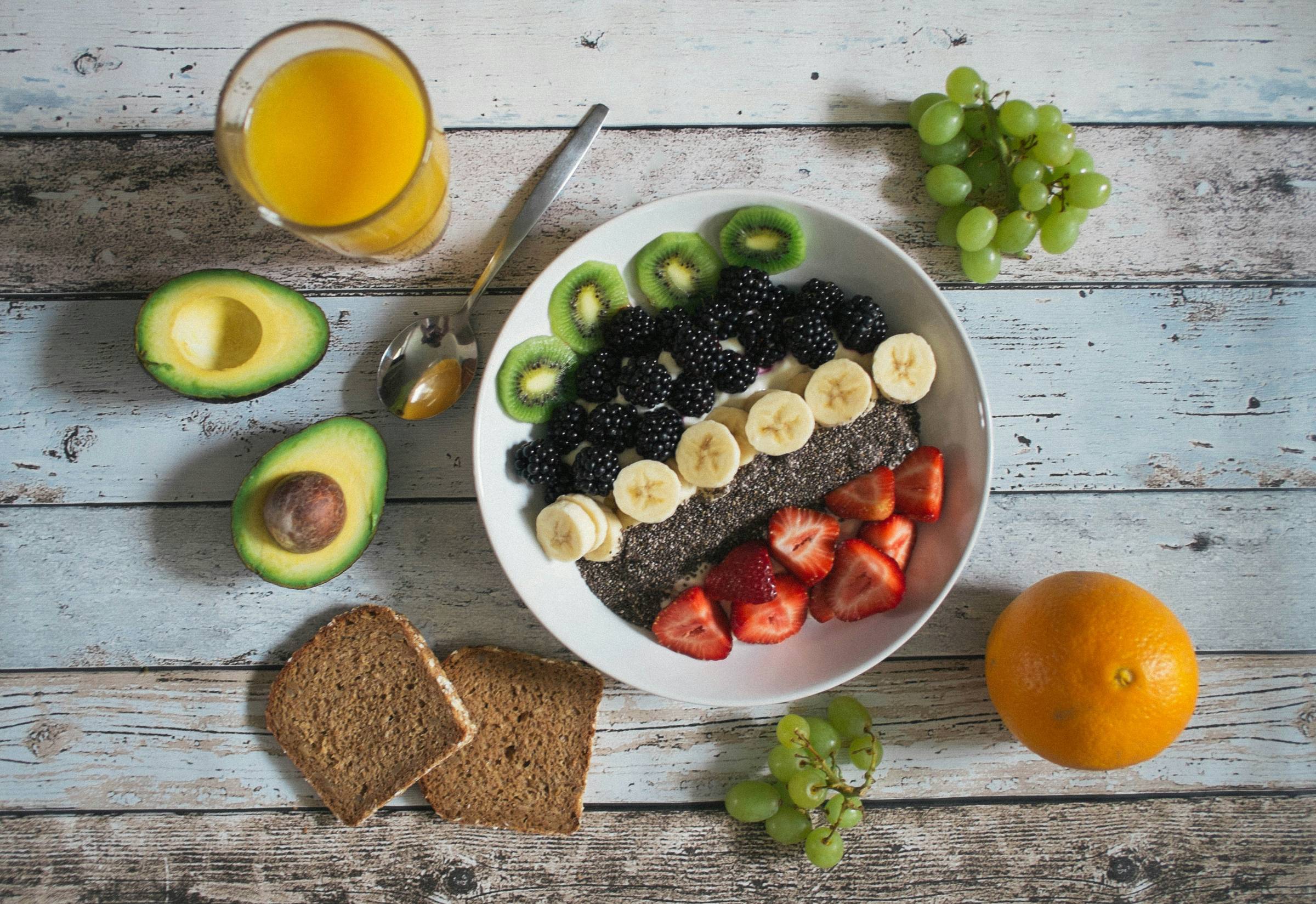 Bowl of fruit on wood table, Photo by Jannis Brandt on Unsplash