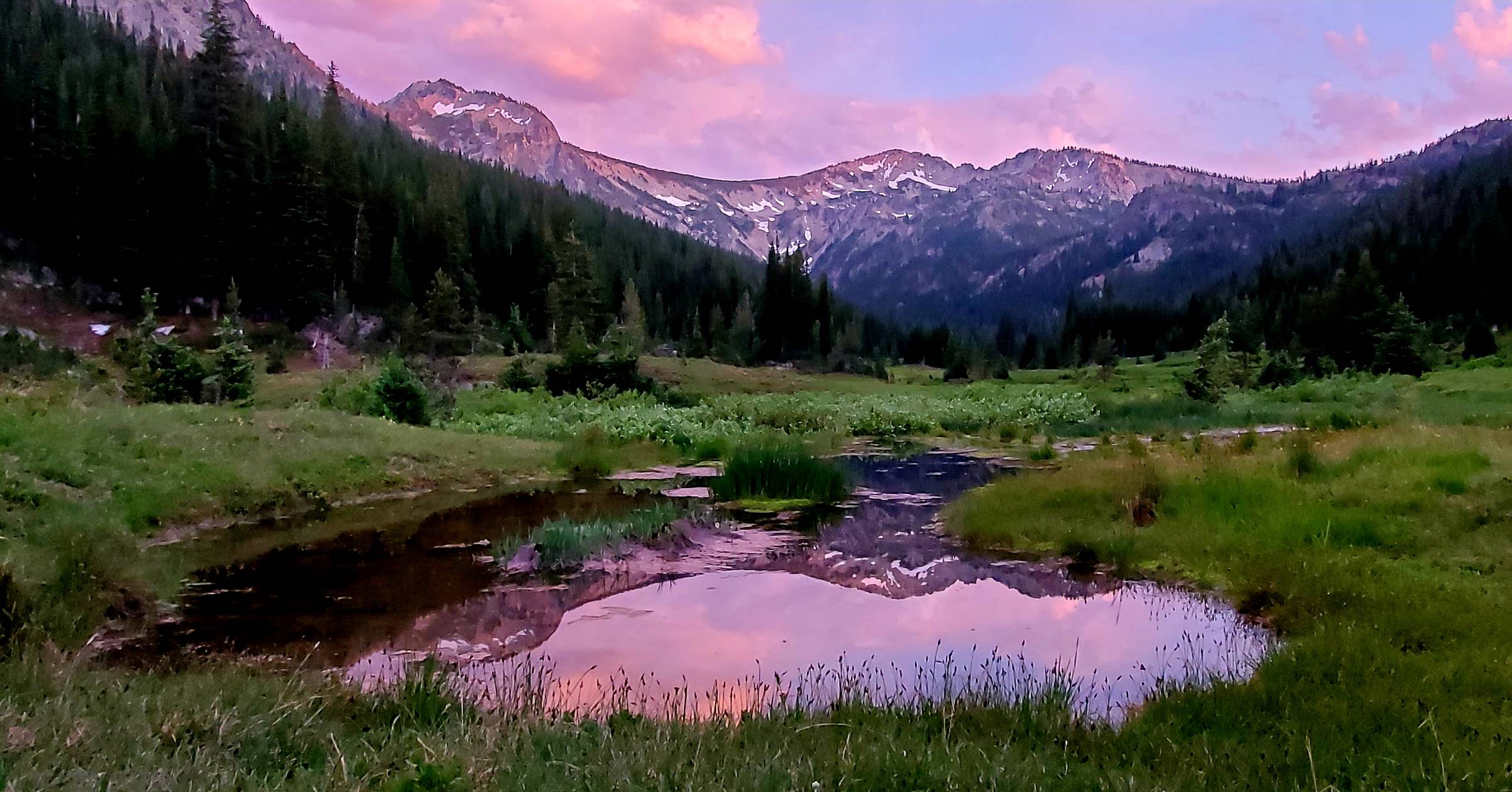 a mountain sunset reflection in a pond