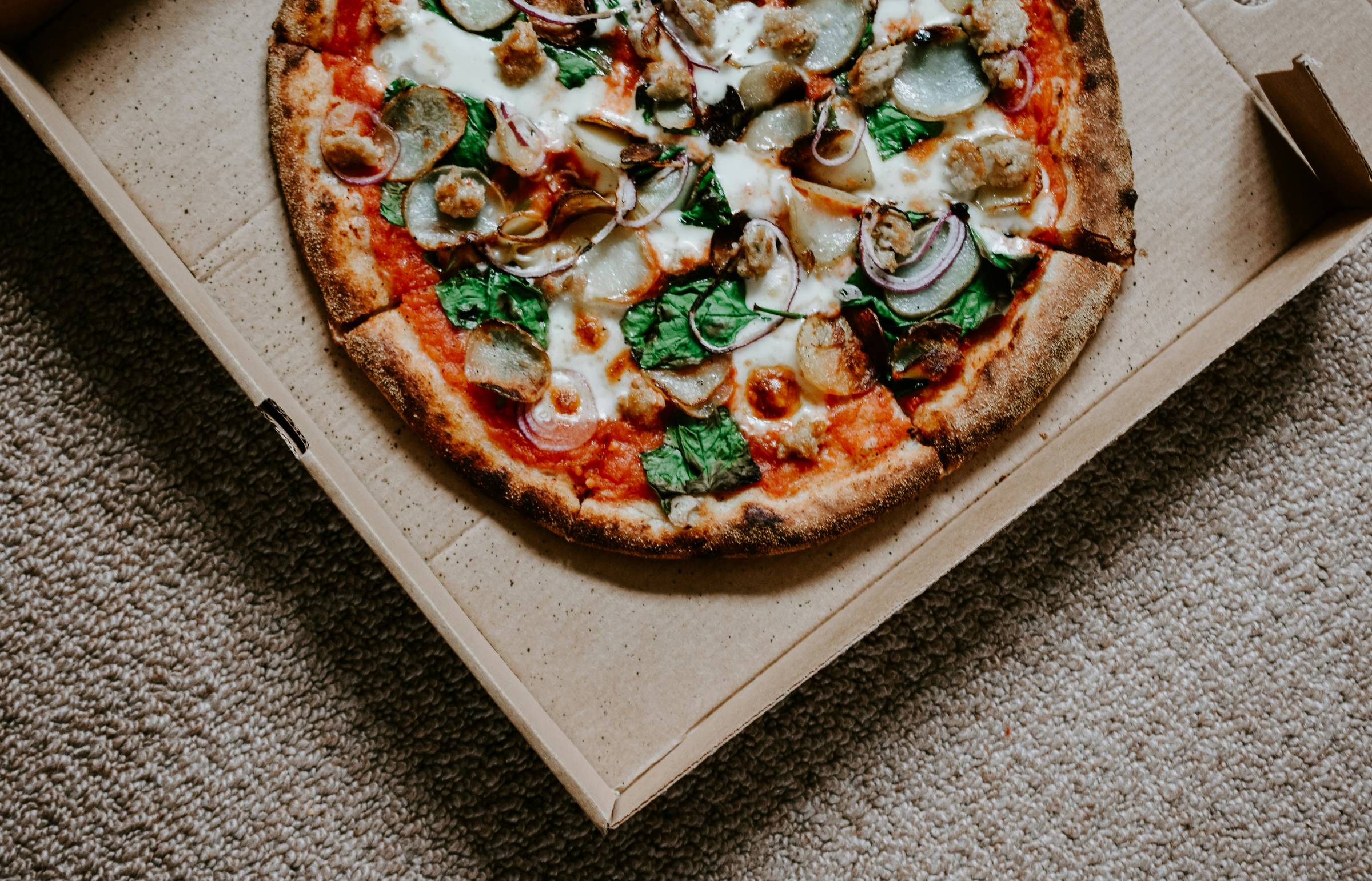 Pizza in a box, Photo by Nik on Unsplash