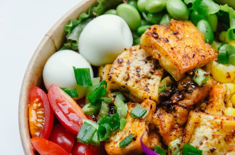 Baked tofu in a bowl with eggs and vegetables
