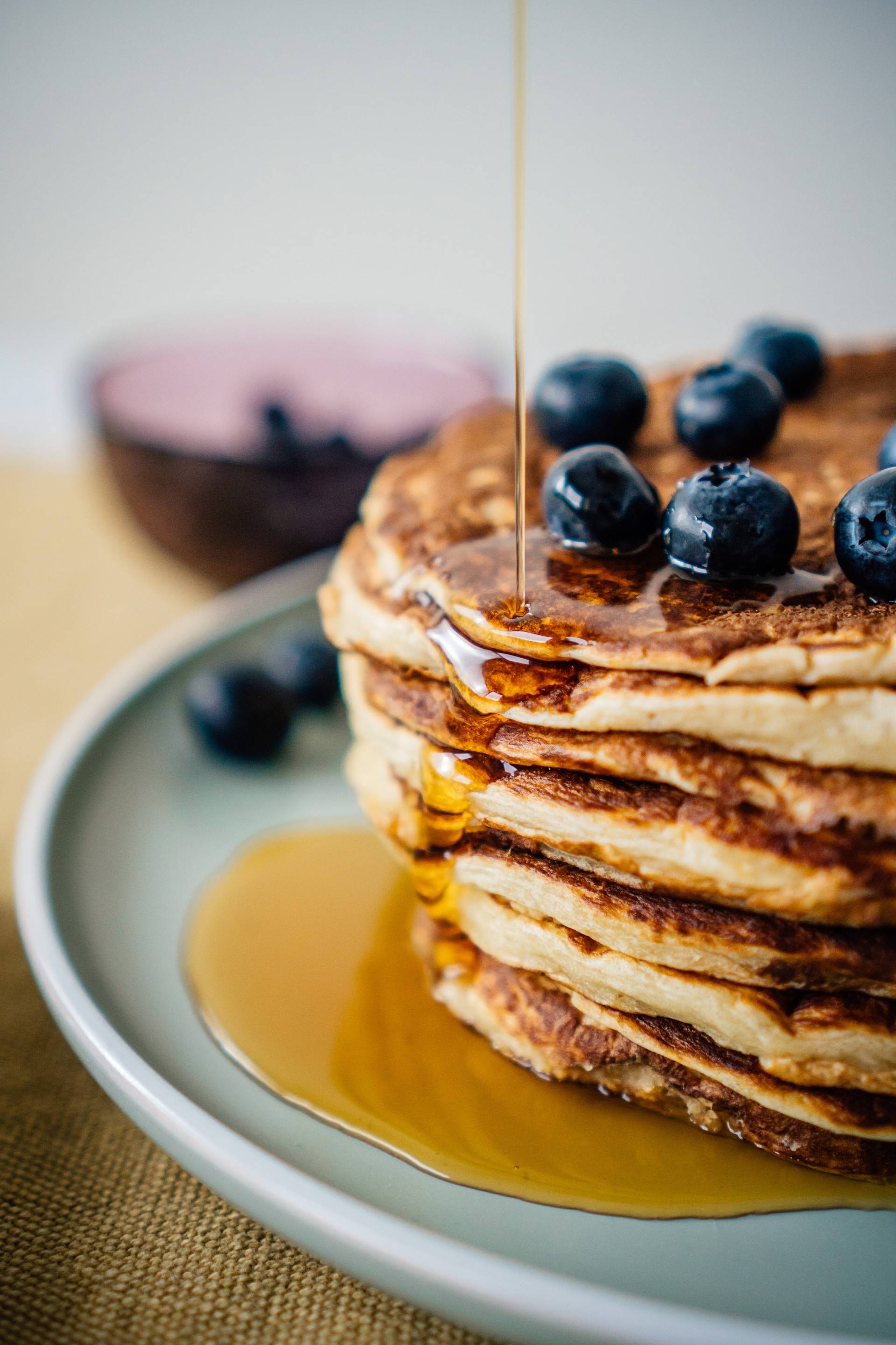 Pancakes with syrup and blueberries on a plate