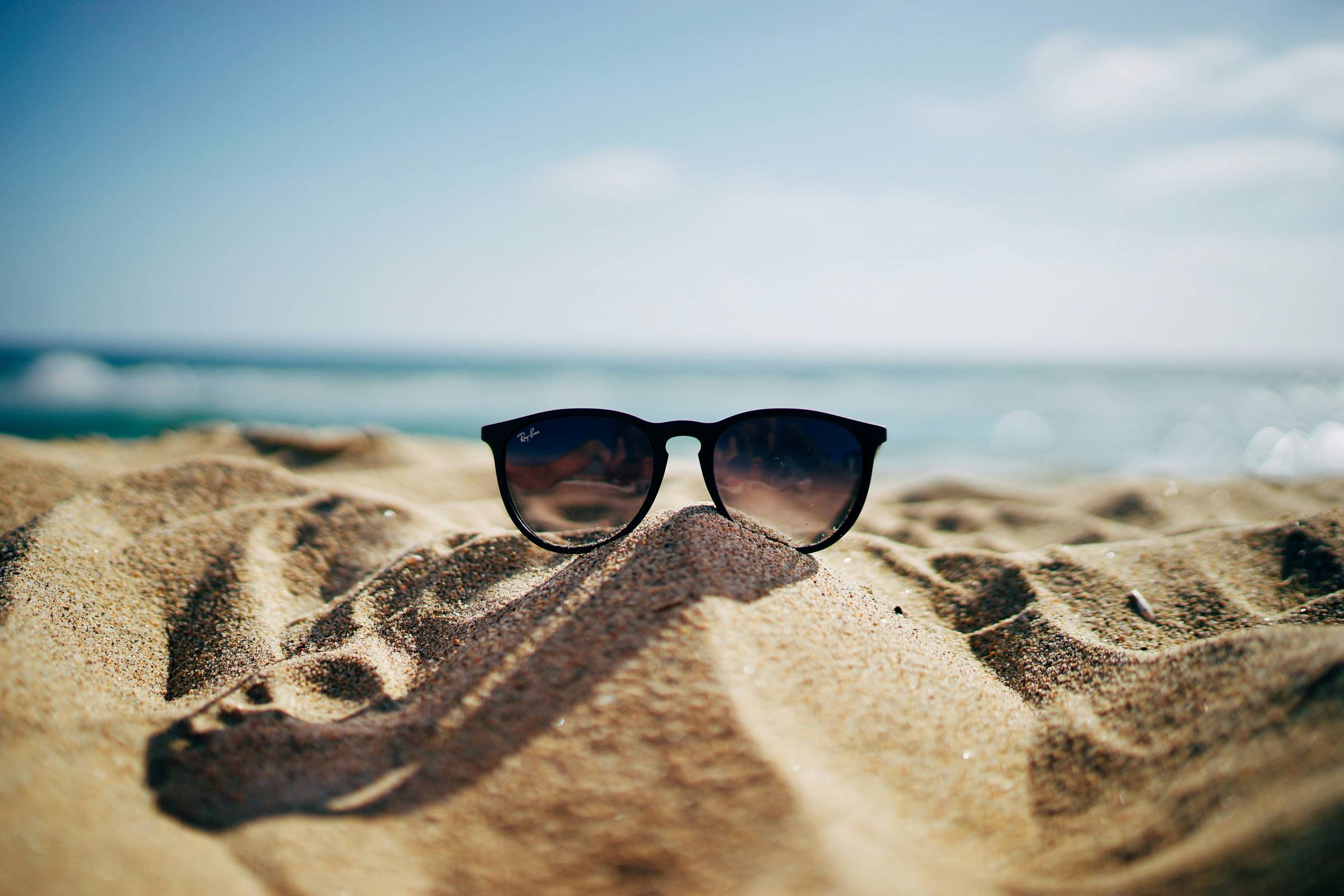 Sunglass on a beach, Photo by Ethan Robertson on Unsplash