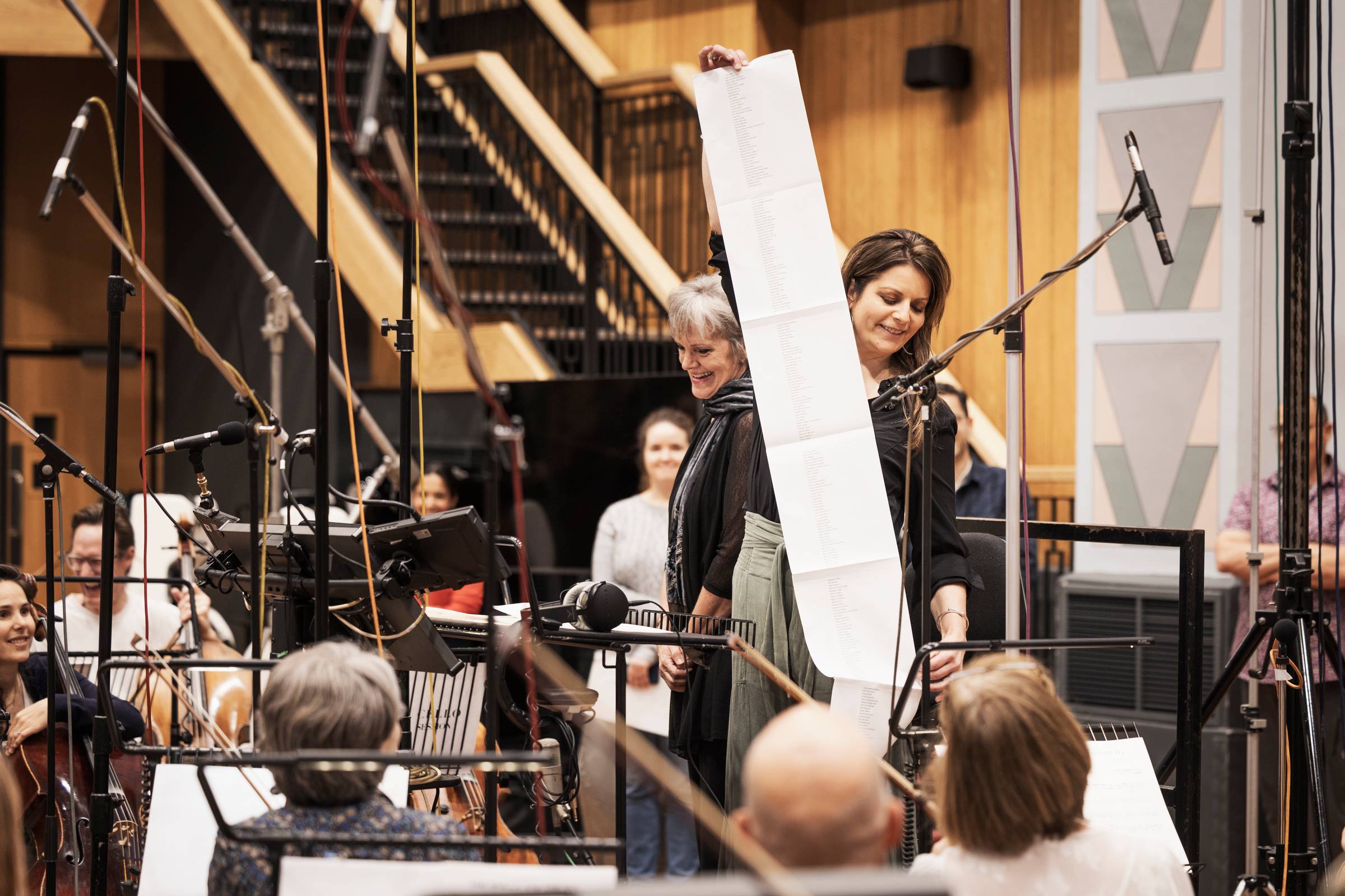 Frances and Kirstin of Double Keyed show the London Symphony Orchestra a list of their 258 supporters for their album project at Abbey Road.