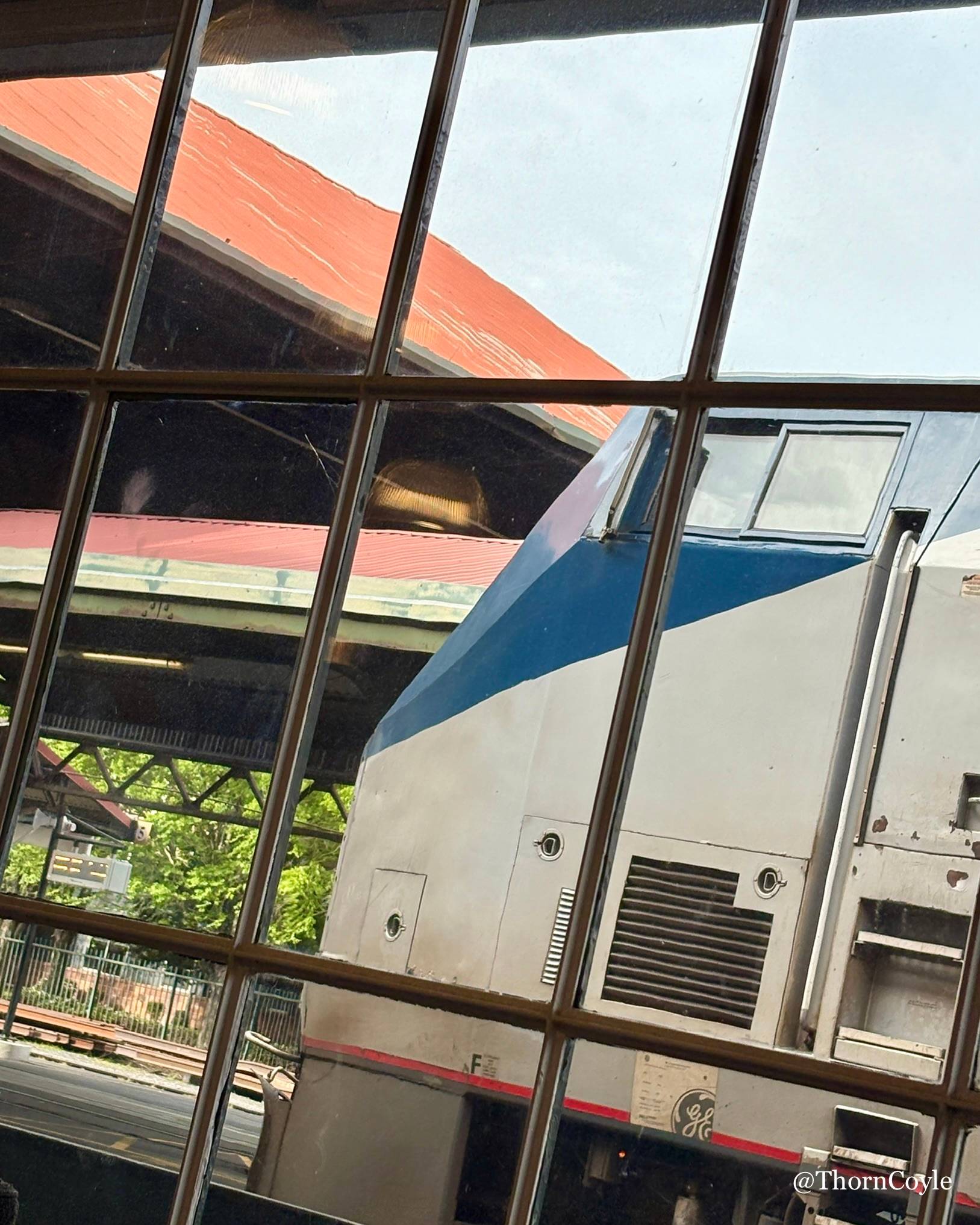 Photo: an Amtrak train in a station, waiting to board