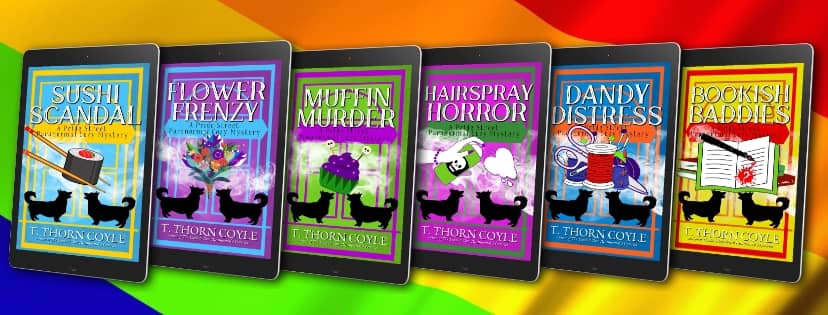 6 cozy corgi mystery ebooks in front of a Pride rainbow flag
