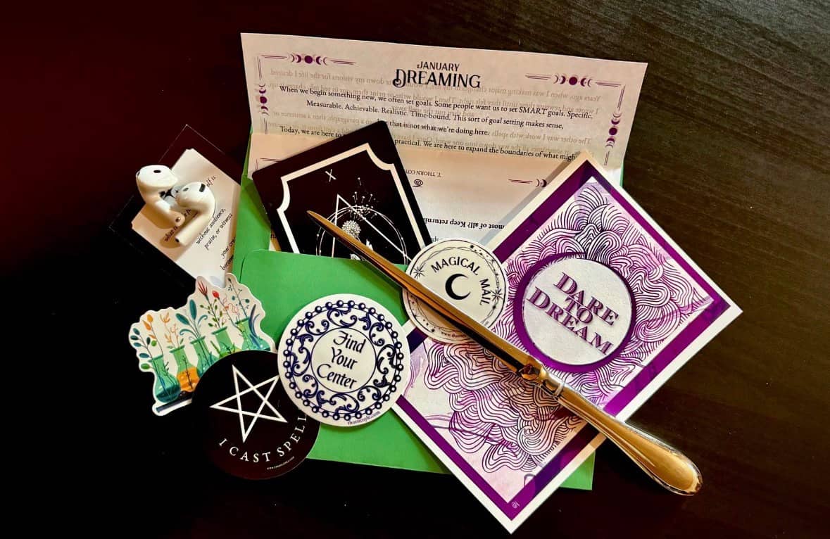 An envelope, a spell letter, stickers, audio, art and a letter opener