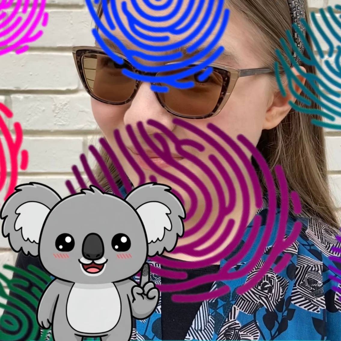Madeline with a koala and colorful fingerprints