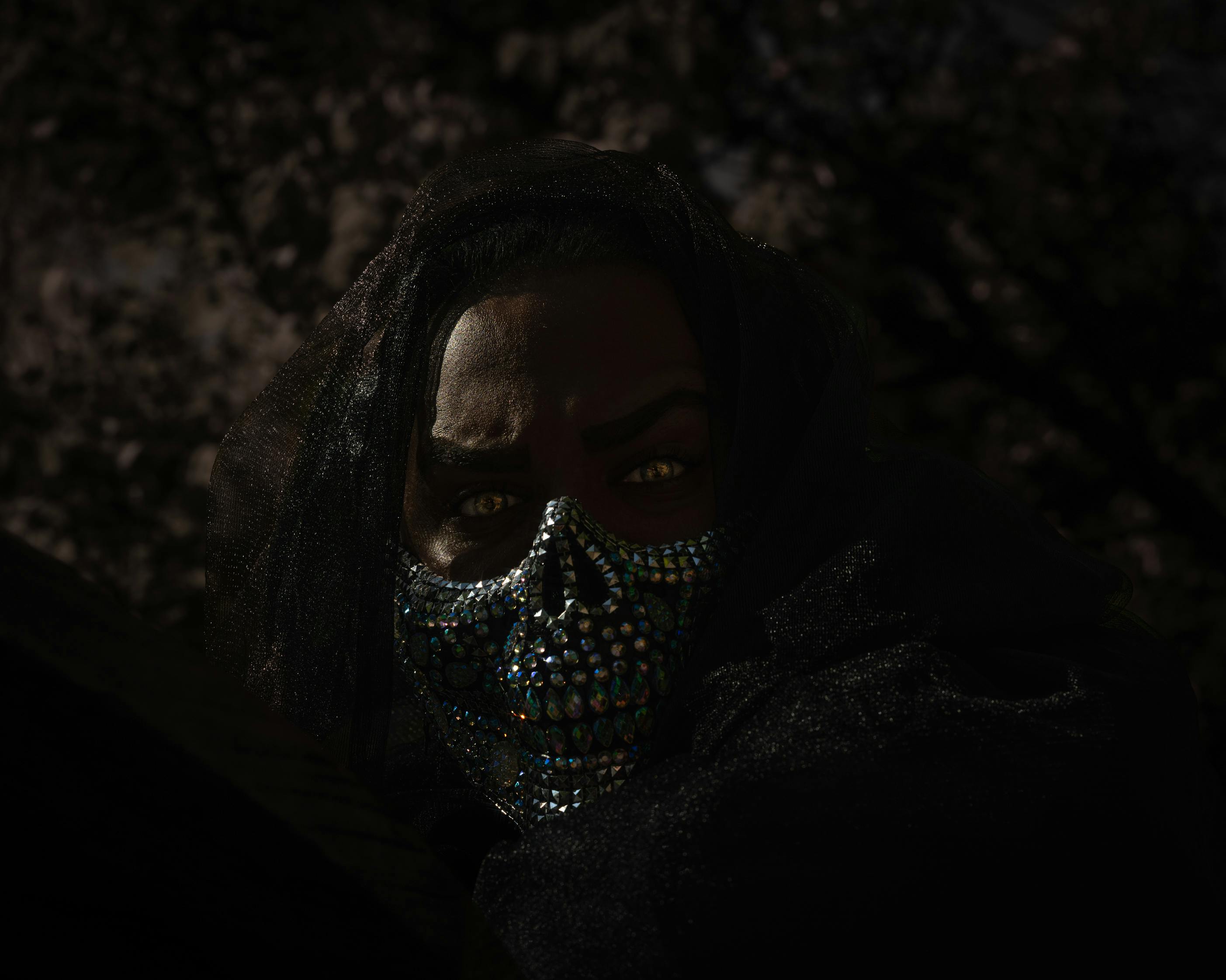 Dark image of masked man.