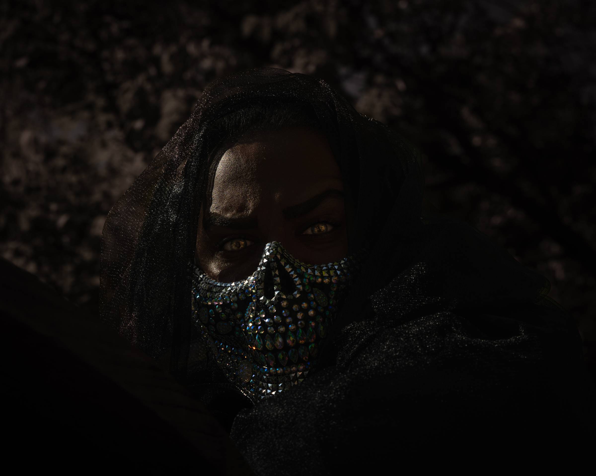 Dark image of masked man.