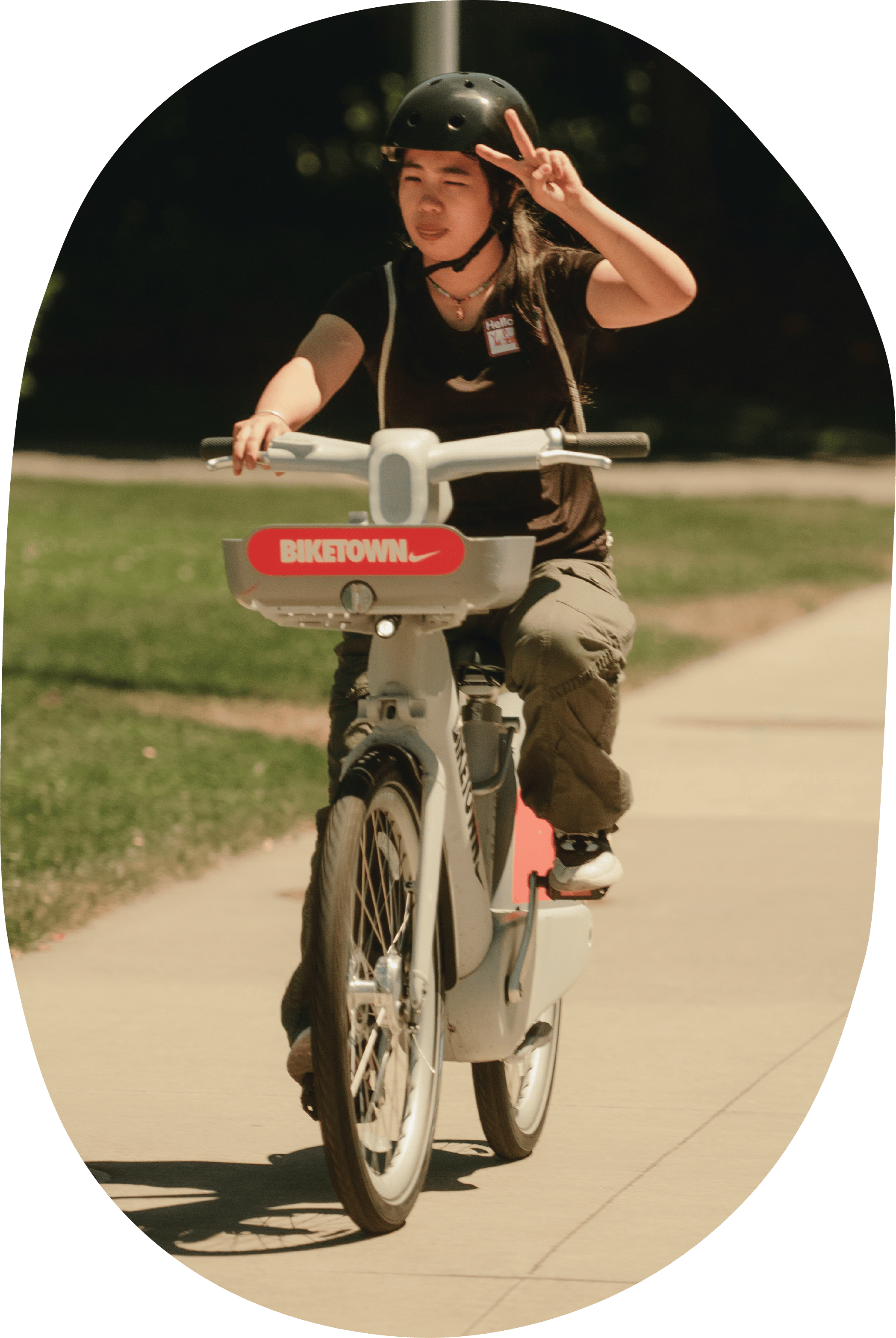 Person on a BIKETOWN bike putting up the peace sign.