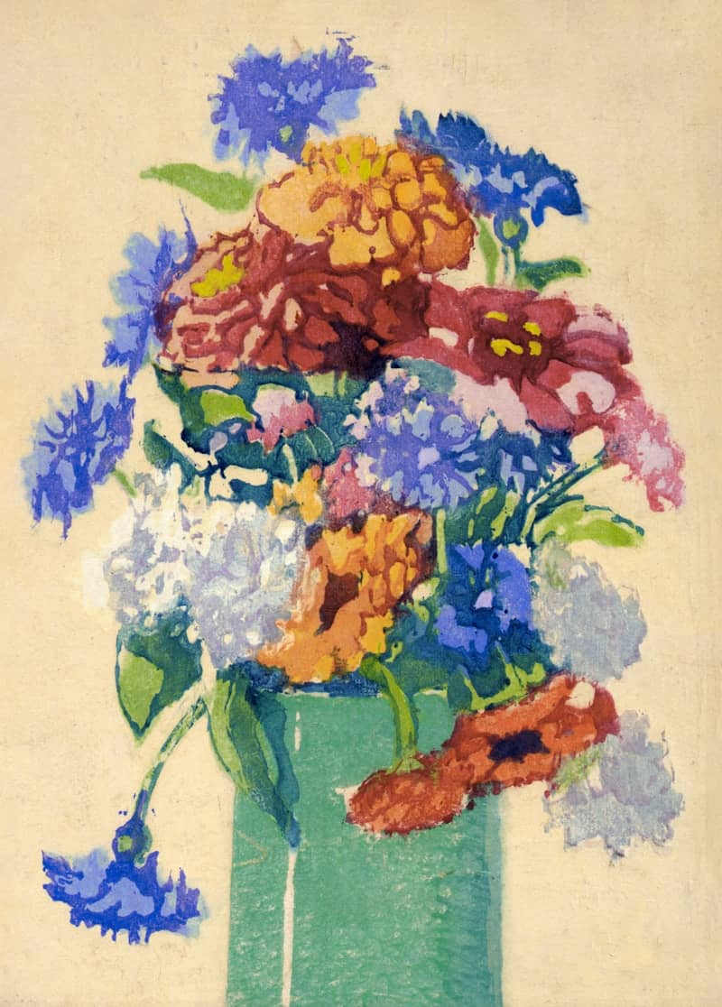 A colorful bouquet of flowers in a green vase