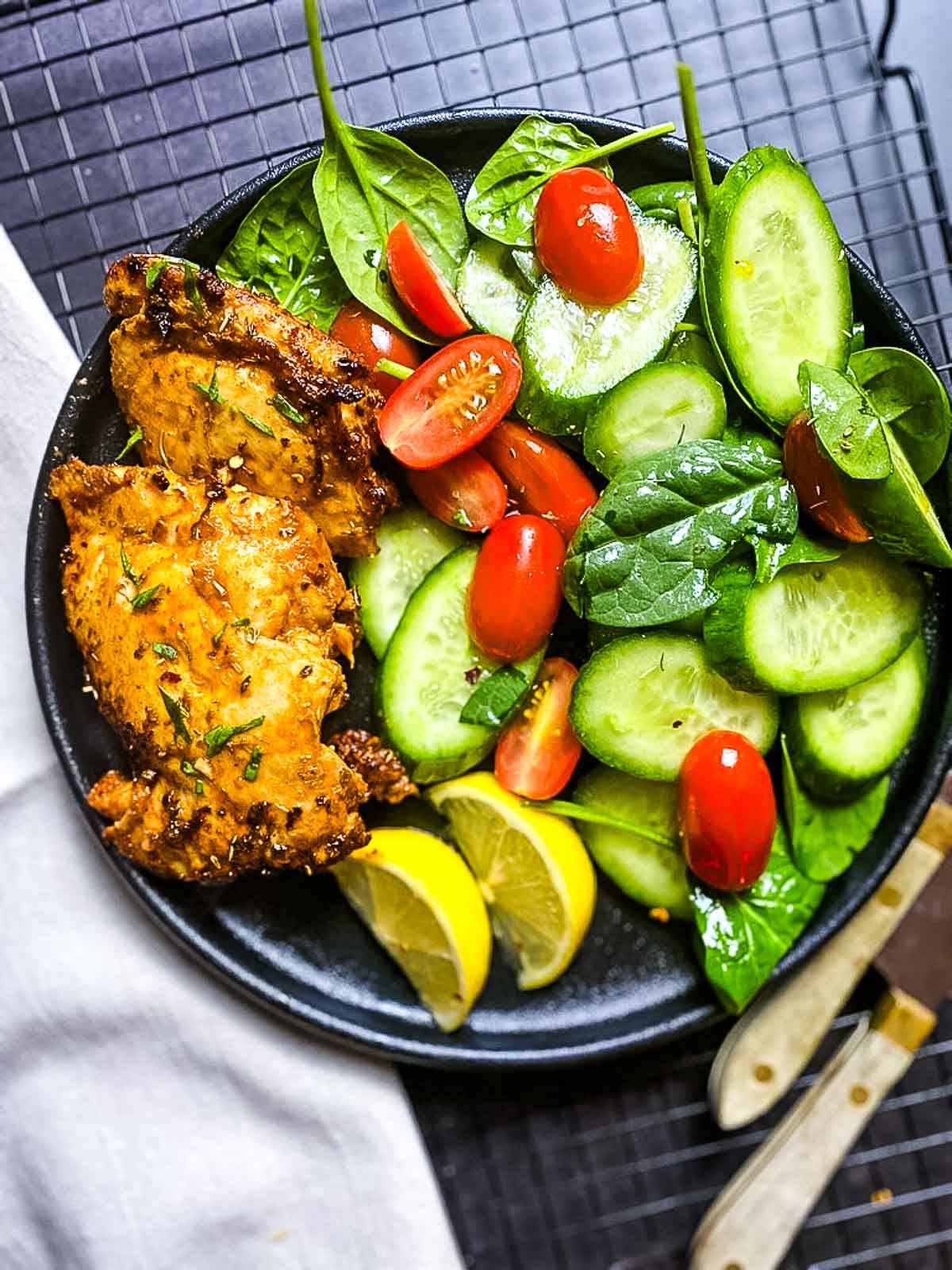 Chicken and salad in a bowl.