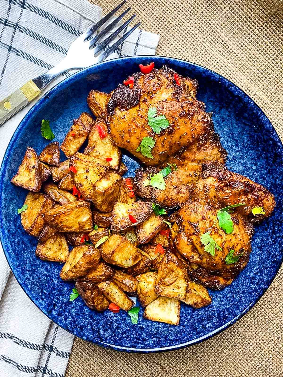 Chicken and potatoes in a plate.