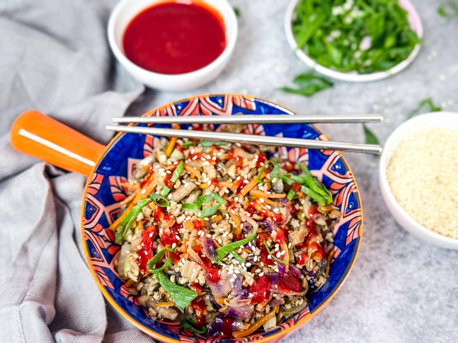 Egg Roll in a bowl with sauces.