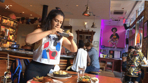 Abby from Broad City attempting to take a photo and dropping her phone