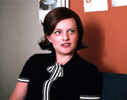 TV gif. Elisabeth Moss as Peggy Olson from Mad Men looks studious with a classy black shirt with stripes running down the middle and a pencil tucked behind her ear. She appears mildly disgusted, as her eyes widen and her lips spread slowly across her face