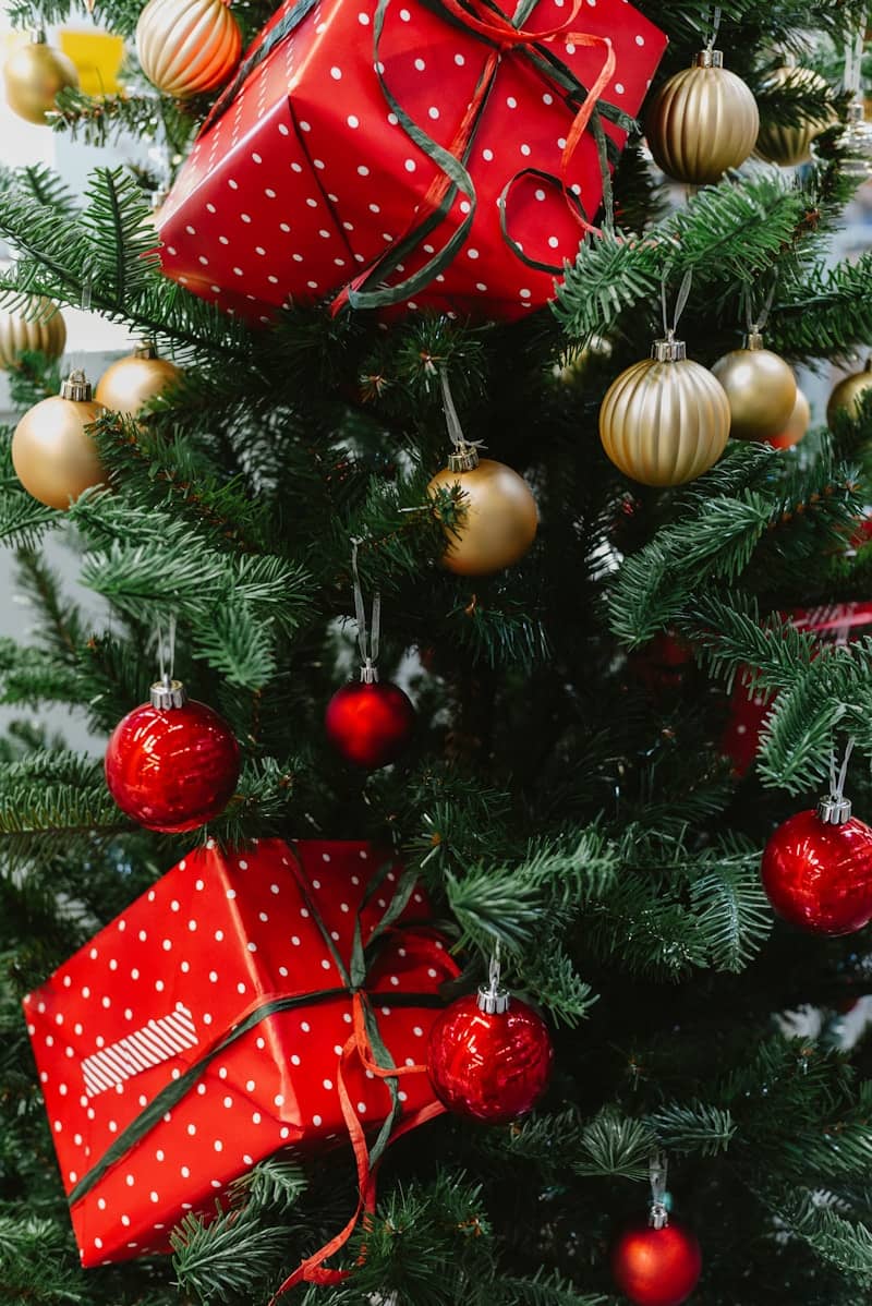 Christmas tree with red and gold ornaments and gifts