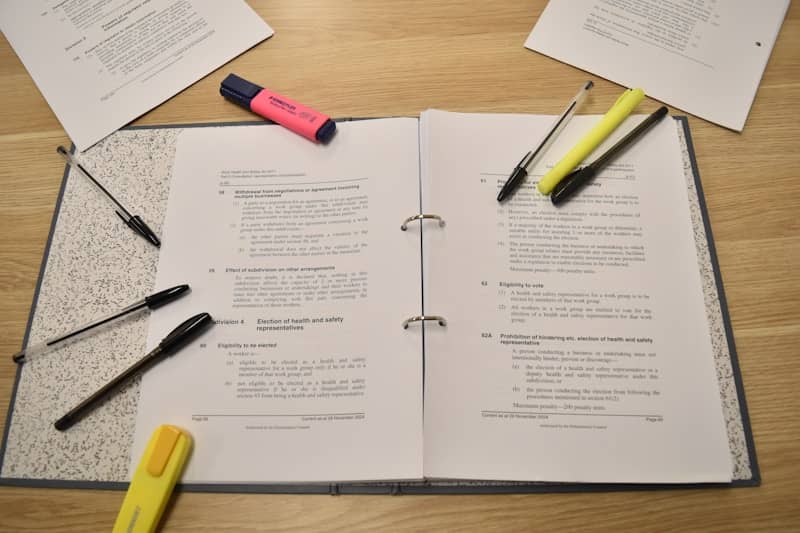 Papers, pens, and highlighters are laid out for studying.