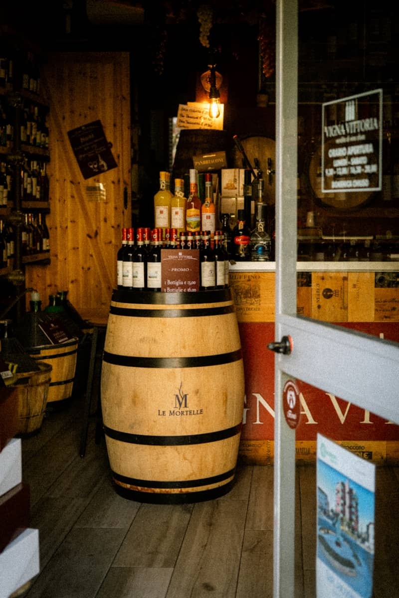 Wine bottles are displayed inside a wooden wine shop.