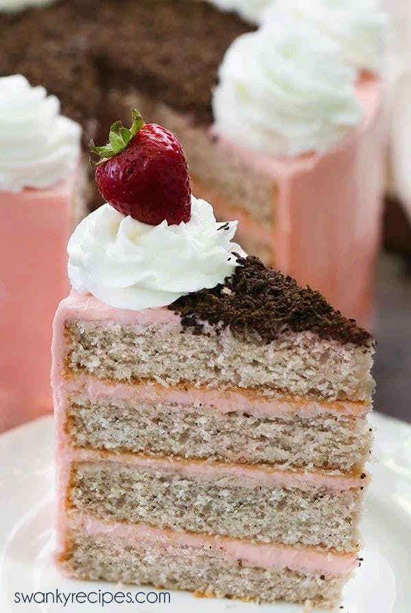 Close-up of a slice of Strawberry Layer Cake one a white plate