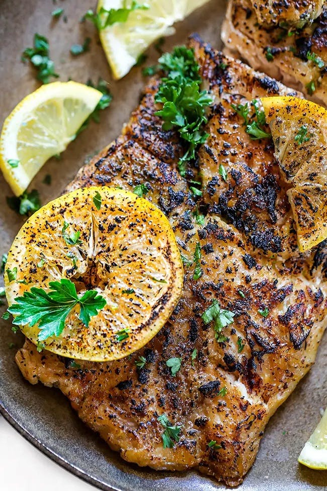 Red Snapper baked then broiled in oven with a golden brown charred top. Topped with broiled lemon slices and parsley.