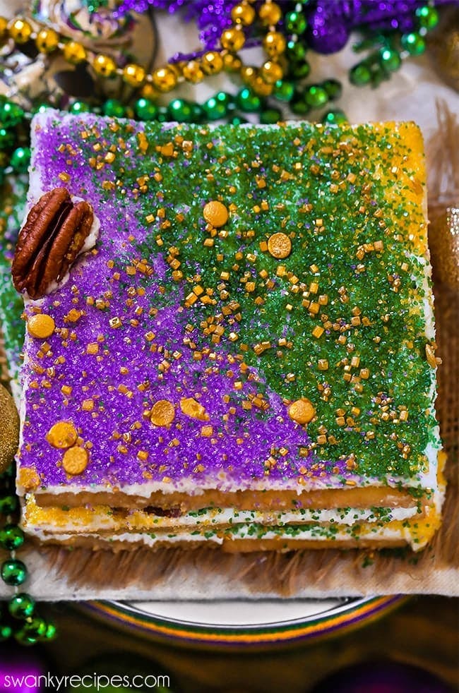 King Cake Candy made with saltine crackers, praline caramel, and king cake flavor frosting.