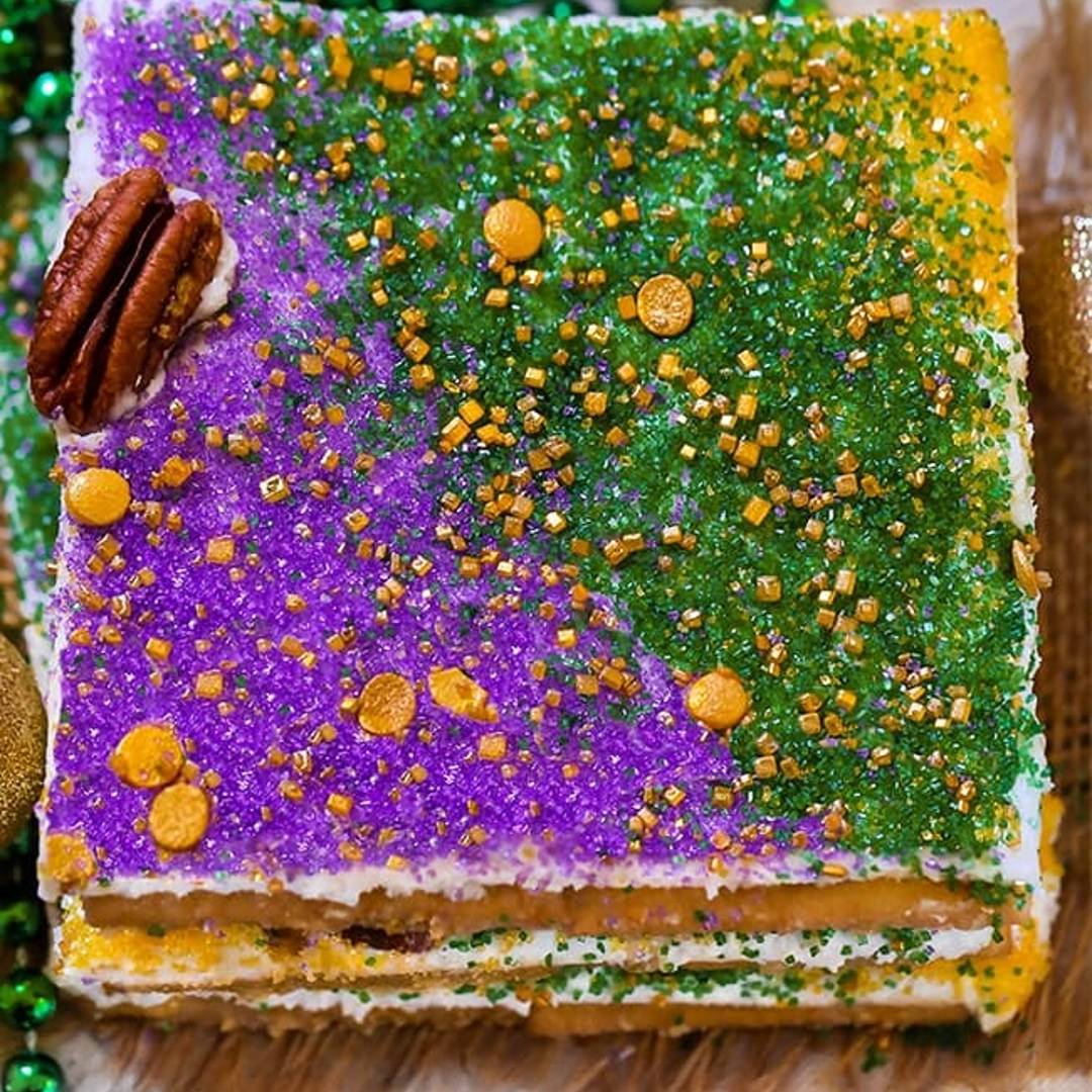 King Cake Candy made with saltine crackers, praline caramel, and king cake flavor frosting.