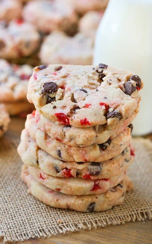 Close-up of shortbread cookies with chocolate chips and maraschino cherry pieces