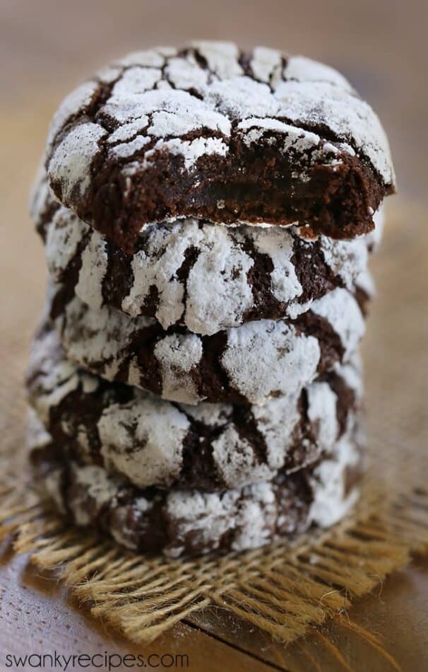 Stack of chocolate crinkle cookies dusted with powdered sugar