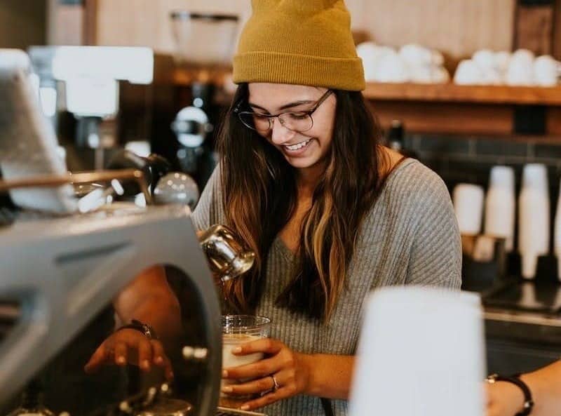 woman holding clear drinking glass