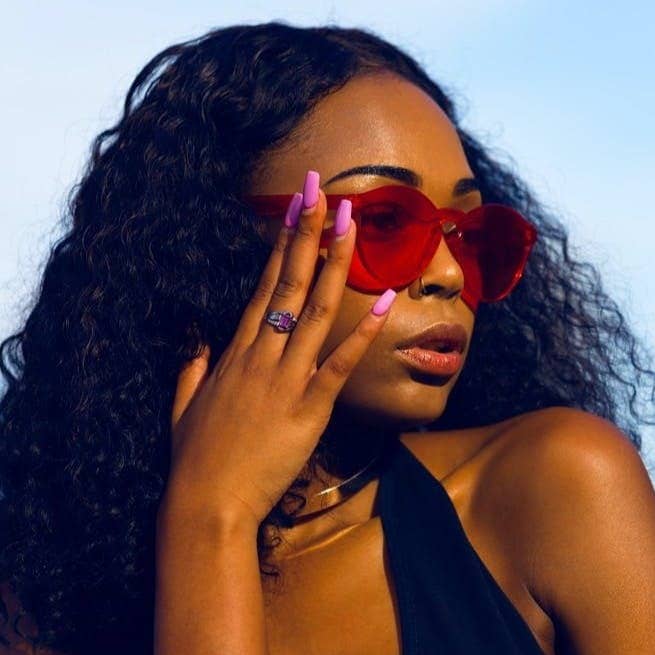 woman holding her sunglasses