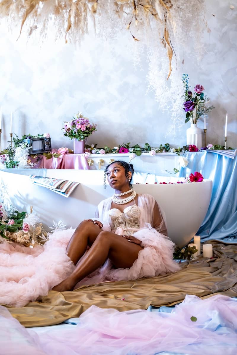 A woman sitting on a bed in a room