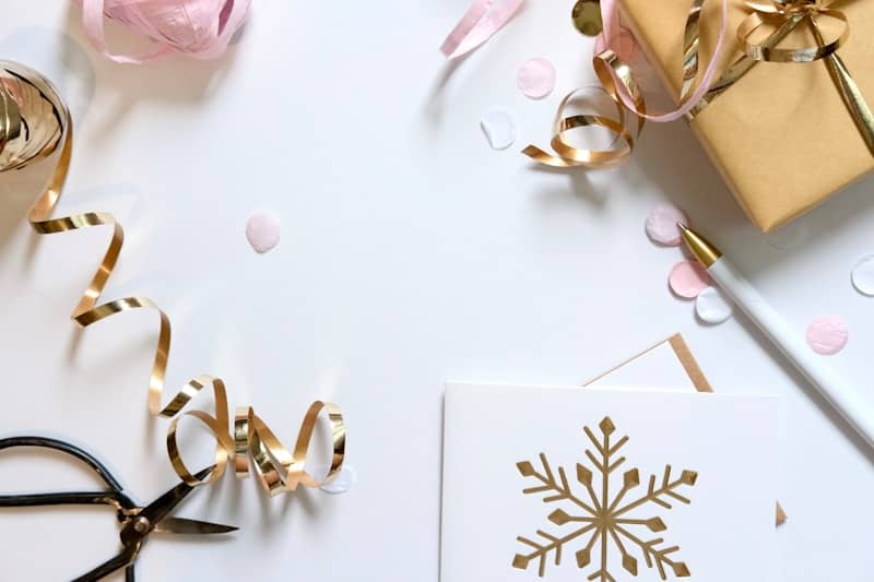 Gift wrapping supplies with snowflake card and ribbon