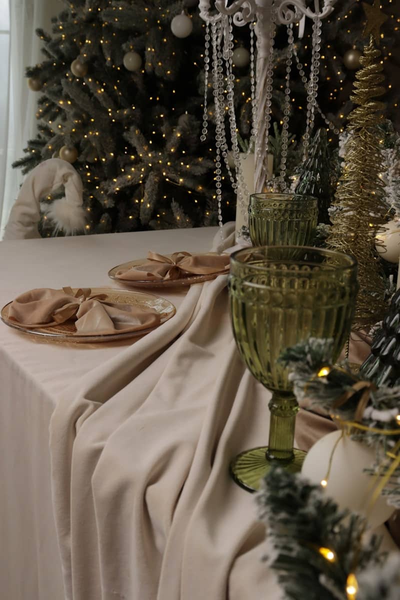 Elegant table setting with christmas tree background