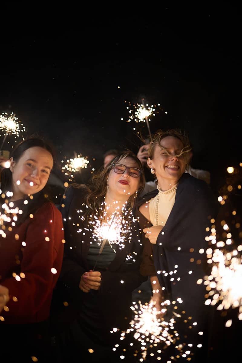 People celebrating with sparklers at night