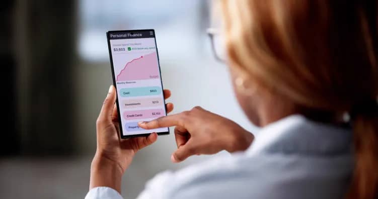 Woman using smartphone to check personal finance and credit card balances