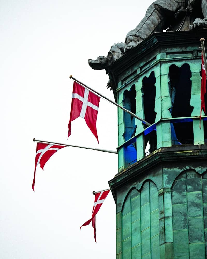 A tall tower with a statue on top of it